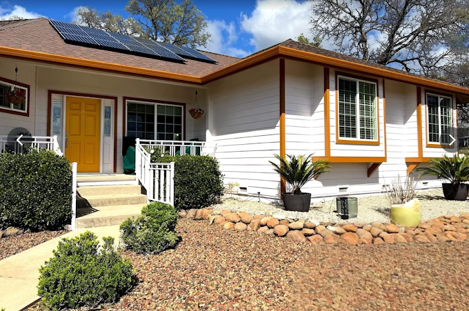 Exterior home repaint with gold front door and trim